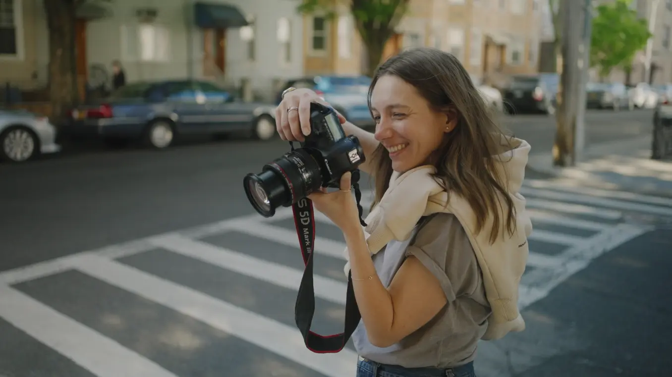 Photographer holding camera and smiling