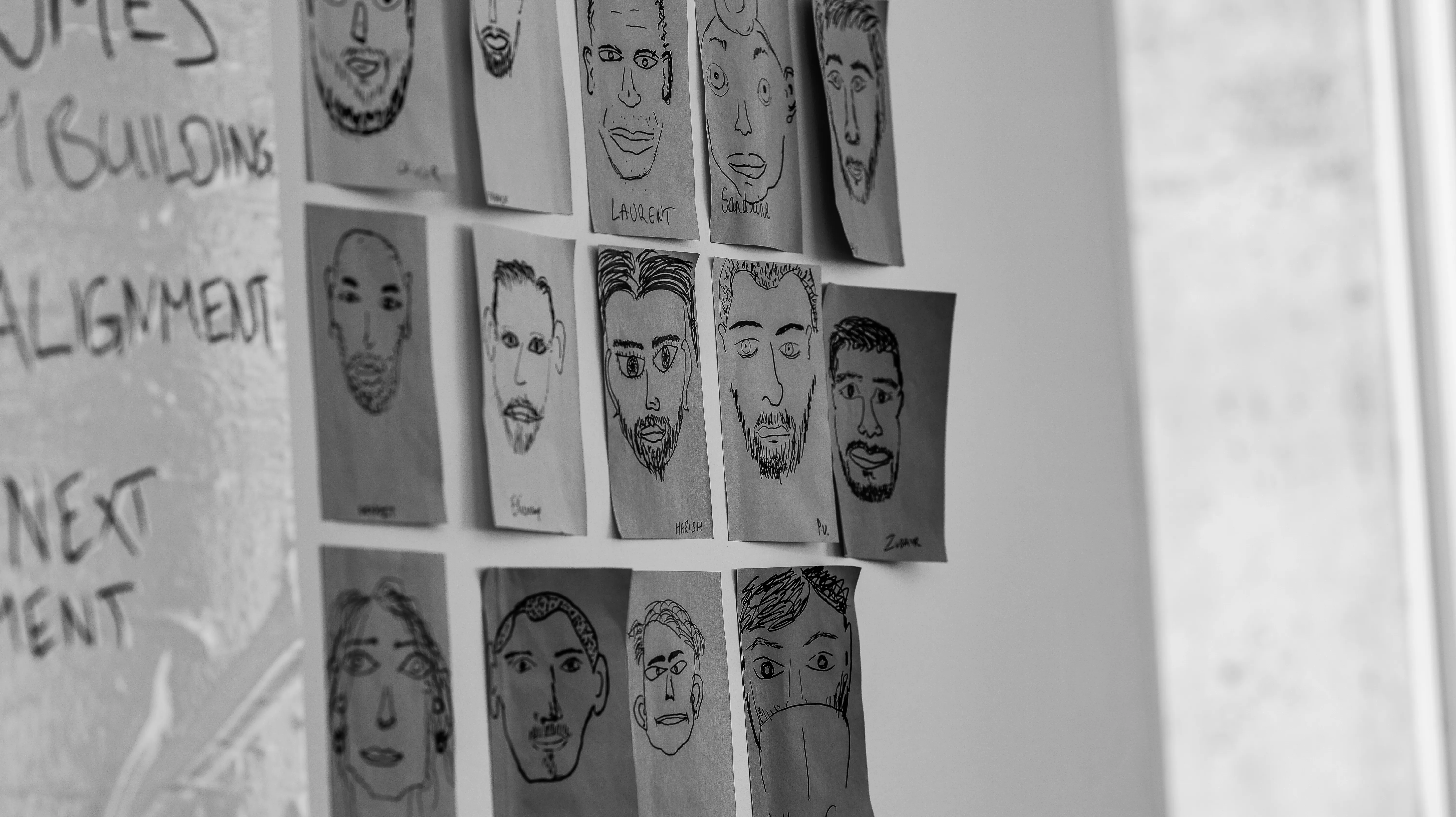 product team portrait sketches on a wall
