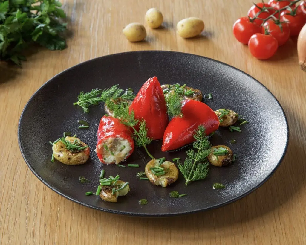 red stuffed peppers on black plate